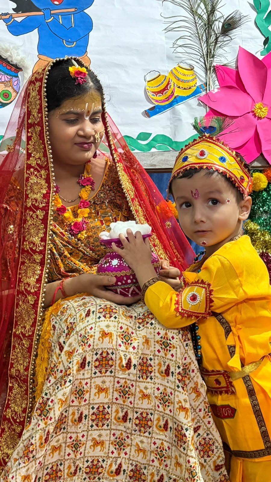 Little Krishna holding a matki of makhan at Janmashtami